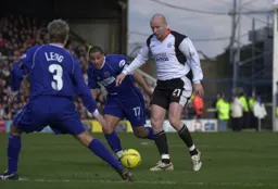 Paul Hughes gets between two defenders