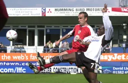Adrian Forbes and Danny Coles go full stretch to challenge for the ball