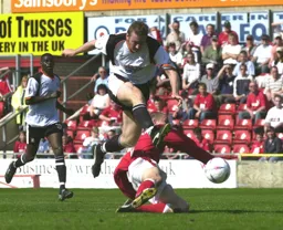 Steve Howard`s shot on goal is blocked by Steve Roberts