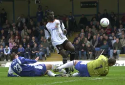 Enoch Showunmi lifts the ball over Carl Muggleton but it goes wide