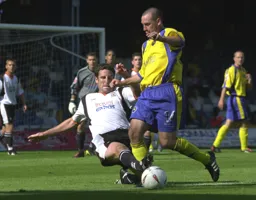 Chris Coyne puts in a crunching tackle