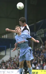 Chris Coyne wins this heading duel