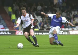 Kevin Foley about to be clattered by Posh's Curtis Woodhouse