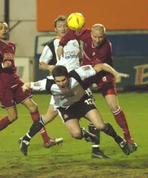 Walsall's Neil Emblen pushes Chris Coyne in the area resulting in the penalty