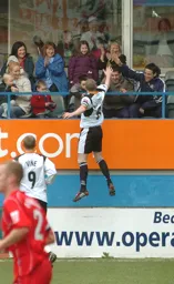 Kevin Nicholls celebrates the goal with injured team mates