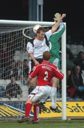 Steve Howard challenges the Barnsley goalkeeper