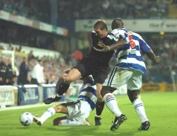 Steven Howard tries to evade a sliding tackle by a QPR player