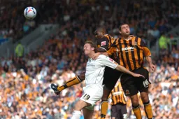 Steven Howard goes up for a header with two Hull players