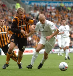 Warren Feeney with the ball, under pressure from a Hull player