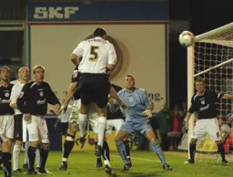 Russell Perrett heads goalwards