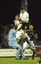 Chris Coyne leaps high above the Sheffield Wednesday defenders