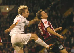 Marcus Heikkinen challenges a Sheffield United player for a header