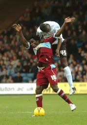 Leon Barnett wins the header