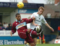 Peter Holmes wins a midfield duel