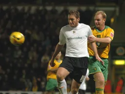 Steven Howard receives the ball under pressure from Gary Doherty