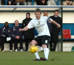 Kevin Nicholls strikes the ball