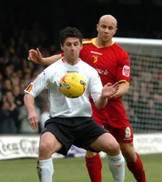 Stephen Robinson controls the ball watched closely by a Watford player