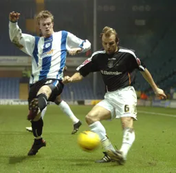 Paul Underwood crosses as a Sheffield Wednesday player tries to block