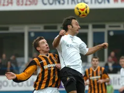 Ahmet Brkovic, challenged by a Hull player, wins a header