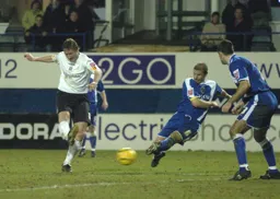 Steven Howard takes strike as a Cardiff player lunges in