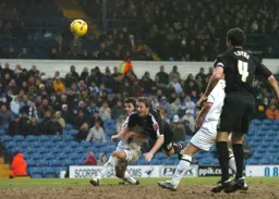 Steven Howard sends in a diving header