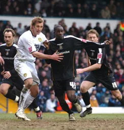 Leon Barnett tries to break free from a Leeds player