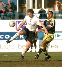 Steven Howard controls the ball challenged by a Derby player