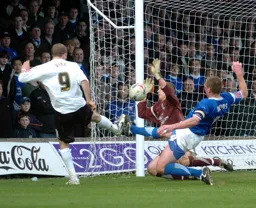 An Ipswich player tackles Rowan Vine as he strikes for goal