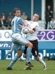 Rowan Vine tussles for the ball with Coventry player