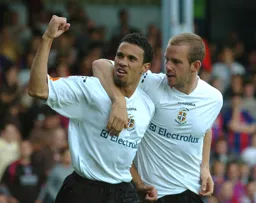 Goal scorers on the day Carlos Edwards and Rowan Vine celebrate after Edwards goal