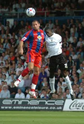 Leon Barnett and Shefki Kuqi jump for the ball