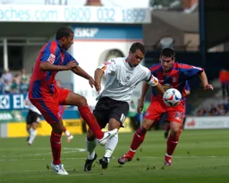 Lewis Emanuel gets through Jobi McAnuff and Danny Butterfield