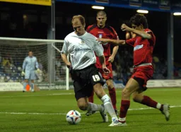 Sam Parkin shields the ball as two defenders close in