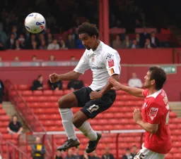 Richard Langley heads clear from Martin Devaney