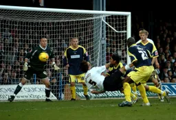 Russell Perrett flies in with a diving header