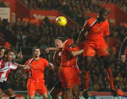 Leon Barnett flicks on a high cross