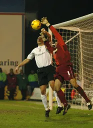 Darryl Flahavan comes under pressure from Warren Feeney