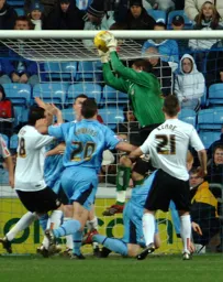 Dean Brill makes a safe catch in a crowded penalty area