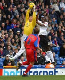 Gabor Kiraly catches the ball away from Leon Barnett