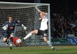 Drew Talbot controls the ball as Luke McCormick rushes off his line