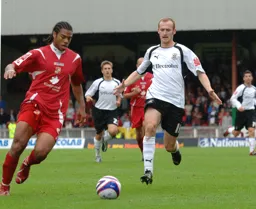 Drew Talbot looks to put pressure on the defender