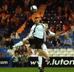 Chris Perry heading the ball away