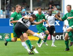 Paul Peschisolido strikes the ball across goal