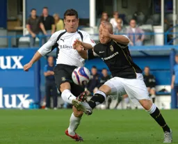 Steve Robinson gets to the ball first