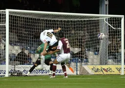Darren Currie heads across goal