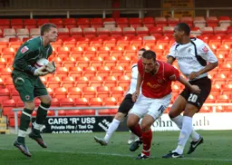 Calvin Andrew watches as his effort towards goal is saved