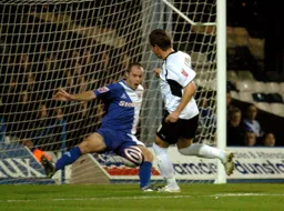 Darren Currie seems certain to score but Carlisle's David Raven blocks his effort