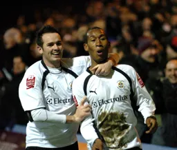 Calvin Andrew celebrates with David Bell