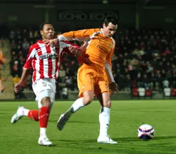 Matthew Spring holding off a player