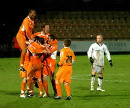 Calvin Andrew leaps in celebration with his team mates